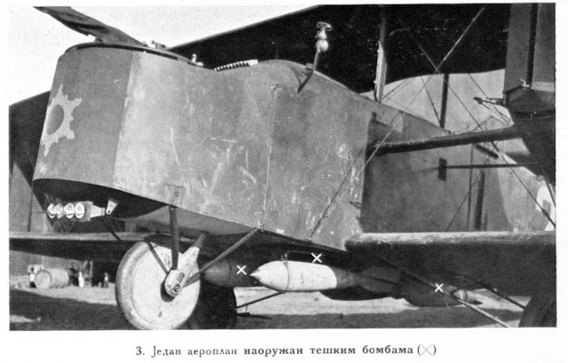 An aeroplane fitted out with heavy bombs which are to be seen