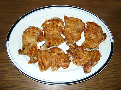 grilled chicken legs without bones on a white plate