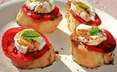 this is Italian salad on top of bread called bruschetta which originates from Rome Italy. It has tomato, cheese, basil and drizzled with olive oil and balsamic vinegar. All in a princess house crystal pie plate to catch the drippings.