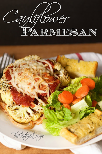 The finished Vegan Cauliflower Parmesan on a plate with a salad and bread with the title above. 