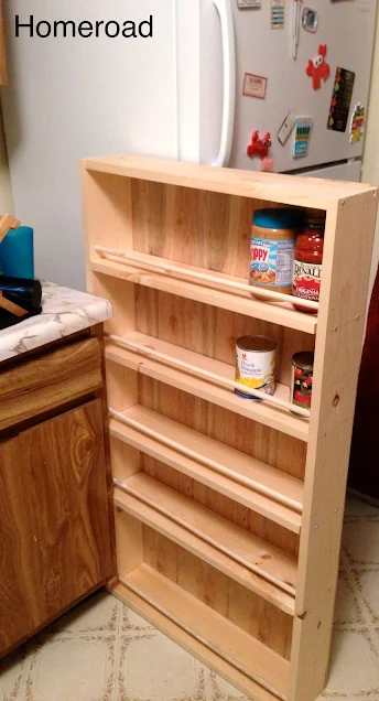 Slide out storage in a small kitchen between the fridge and the sink