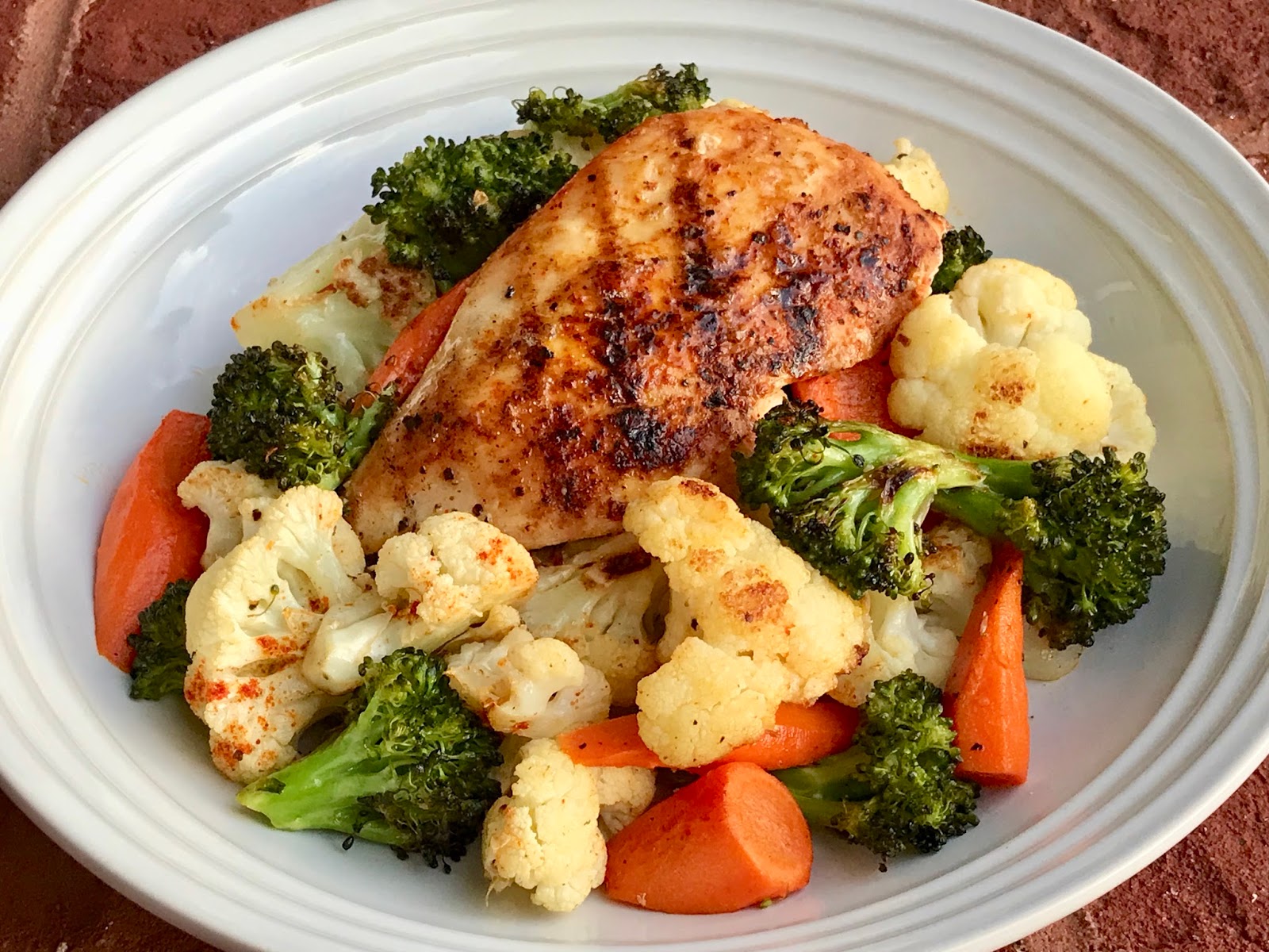 Gourmet Girl Cooks Grilled Chicken atop a Roasted Vegetable Medley