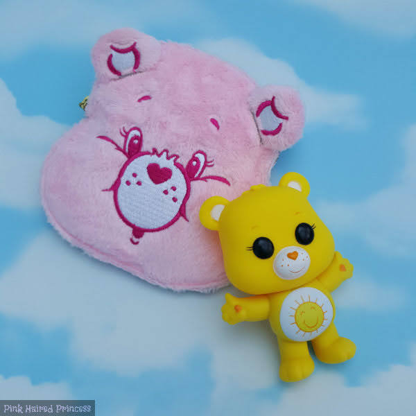 pink cheer bear shaped purse with yellow care bear pop vinyl