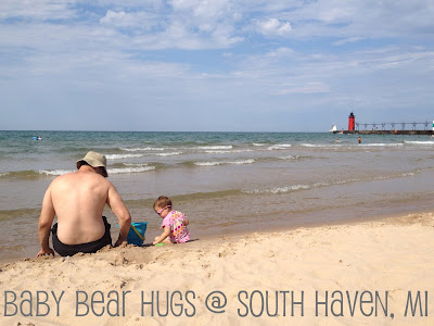 dad and child on the beach with a sand castle South Haven, MI