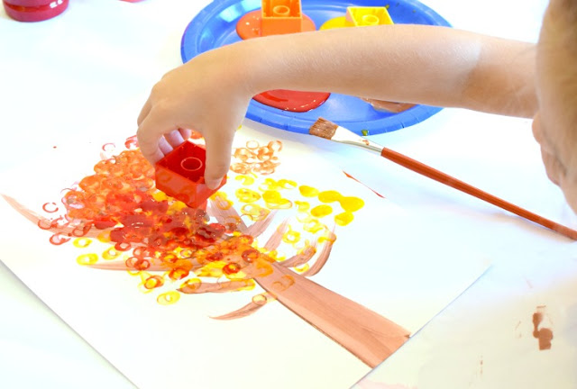 LEGO Stamped Fall Tree Craft for Kids. Use LEGO or DUPLO bricks to paint leaves in beautiful fall colors! Fun autumn printmaking activity for preschool, kindergarten, or elementary.