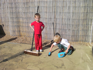 slave labour sweeping the back yard