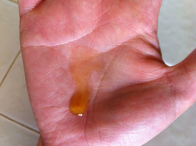 This is a picture showing a pump of Annmarie Facial Oil up close on my hand.