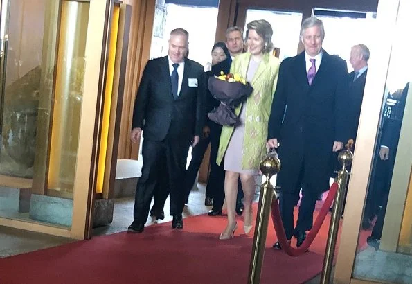 Queen Mathilde wore a green floral print coat by Emporio Armani, and Dries Van Noten grey satin floral coat, Armani bag and Armani pumps