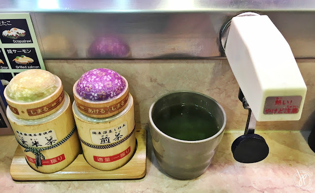 Matcha green tea powder, hot tea, and water dispenser at Genroku Sushi