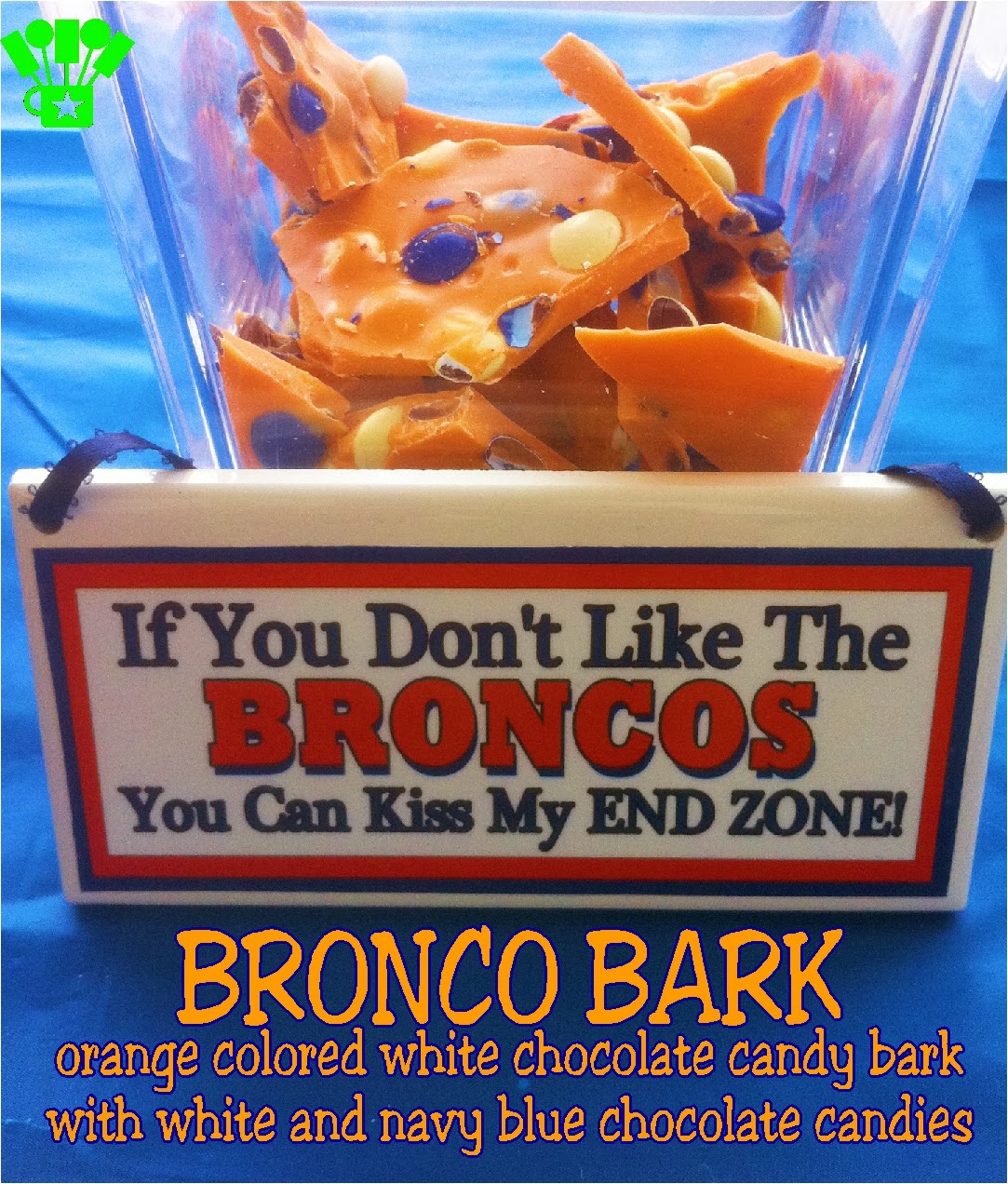 Denver Bronco Candy Bark. An orange colored white chocolate candy bark with white and navy blue chocolate candy pieces.  YUMMY! And great for cheering on the Broncos #Broncos #Candy #SuperBowl
