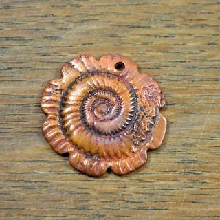 http://www.etsy.com/listing/166486575/handmade-copper-ammonite-focal-pendant?ref=shop_home_active&ga_search_query=ammonite
