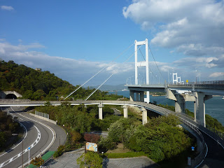 View from the Imbari, Shikoku side of the Kurushima-Kaikyo bridge with the looping downramp of the Shimanami Kaido bike way in the foreground  