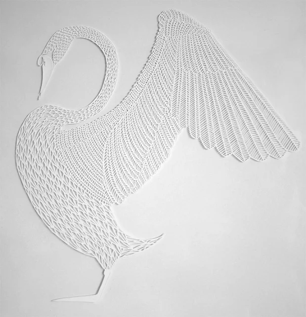 detailed white paper cutting of swan with wings extended