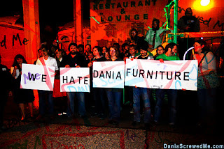 "we hate dania furniture" sign held together by page 1 partiers