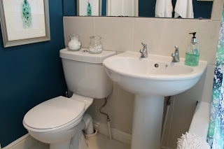 A before and after look at my bathroom with peacock blue paint