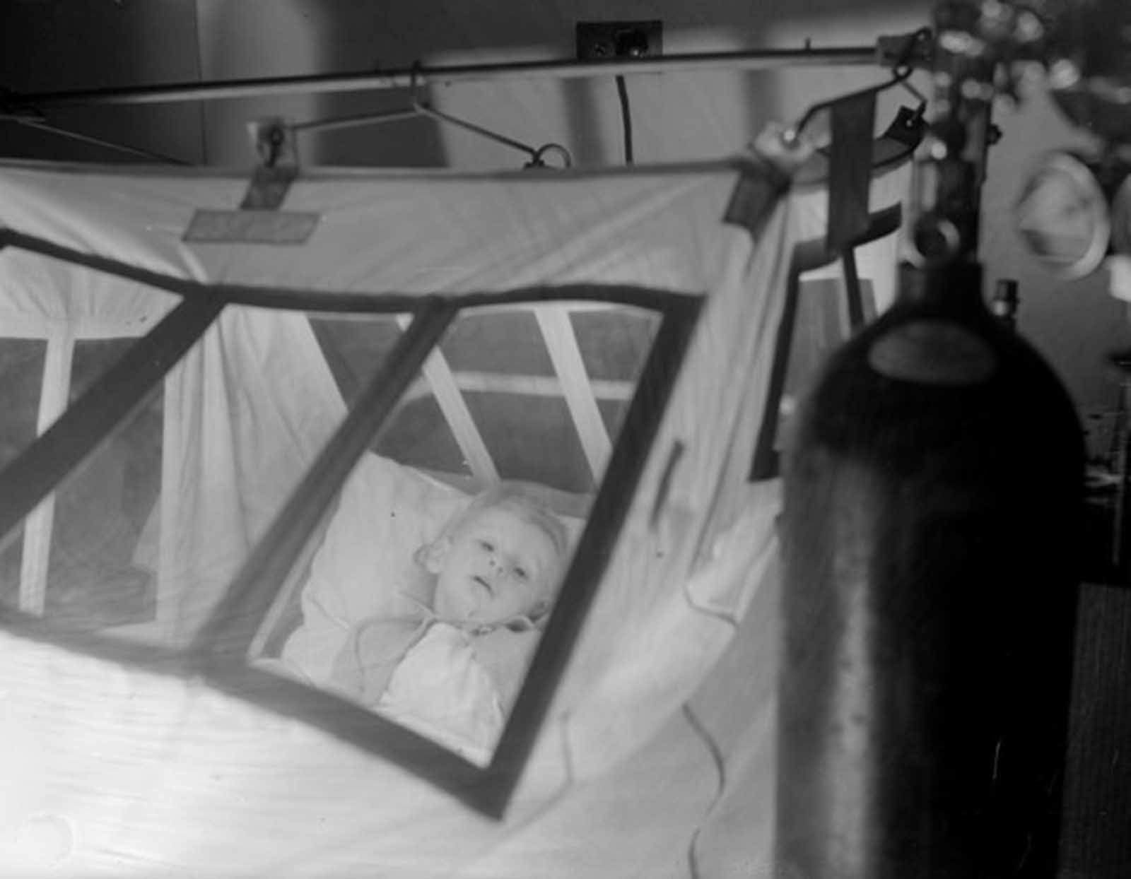  A young patient, Gerald Blackburn, in an oxygen tent at Princess Beatrice Hospital, circa 1937. 