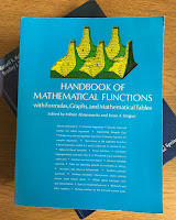 Handbook of Mathematical Functions with Formulas, Graphs, and Mathematical Tables, by Abramowtiz and Stegun, on top of Intermediate Physics for Medicine and Biology.