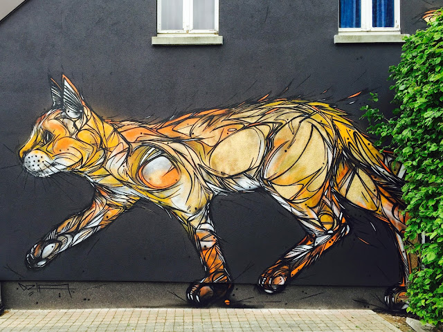 While you discovered his latest pieces in Turin a few days ago, DZIA is now back in Belgium where he directly queued a new cat mural in the city of Zolder.