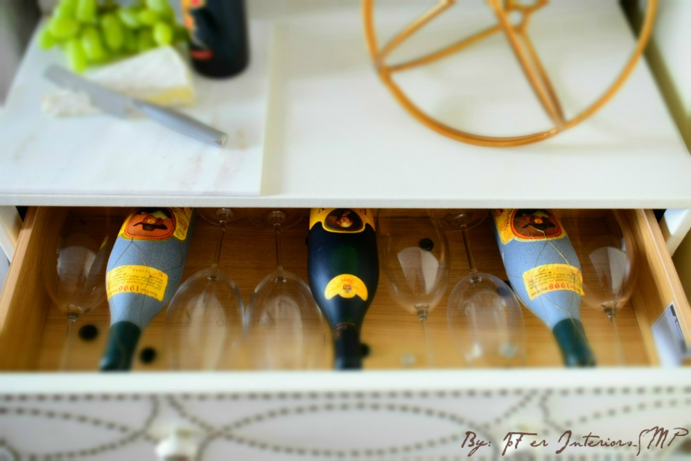 Wine bottles and glasses stored and displayed in a re-purposed chesser drawer 