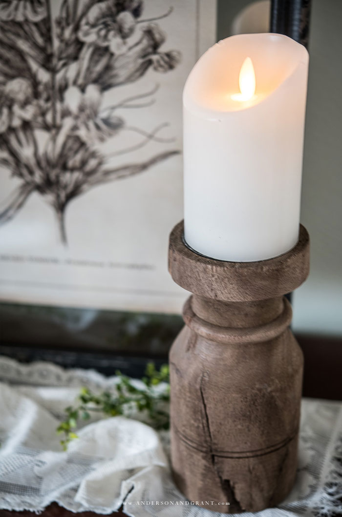 Reclaimed wood candle holder with white candle.