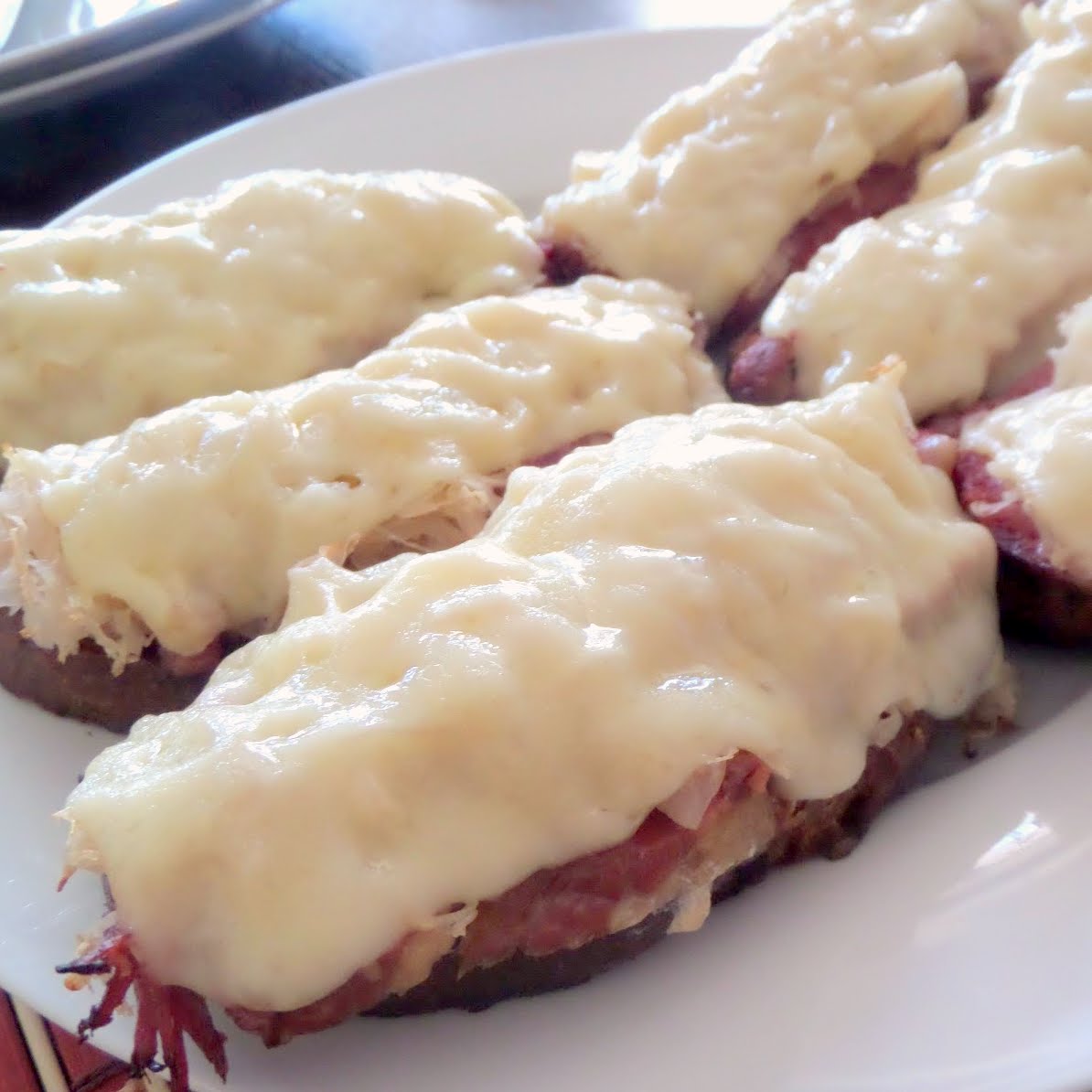 Open Faced Reuben Melts:  All your favorite Reuben ingredients piled on crostini and ready for a quick meal, appetizer, or football snack.