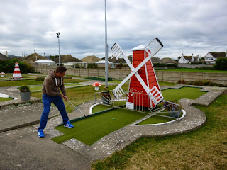 Playing the windmill hole at Prestatyn's Crazy Golf course