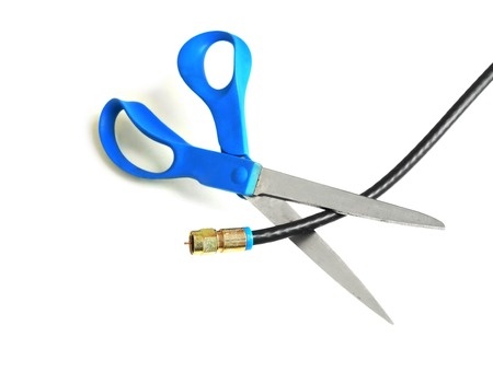 Scissors cutting TV cable
