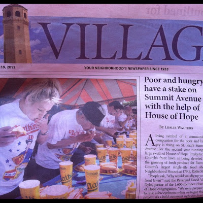 Front page of Highland Villager newspaper with photo of people in an eating contest next to headline about homeless and hungry people