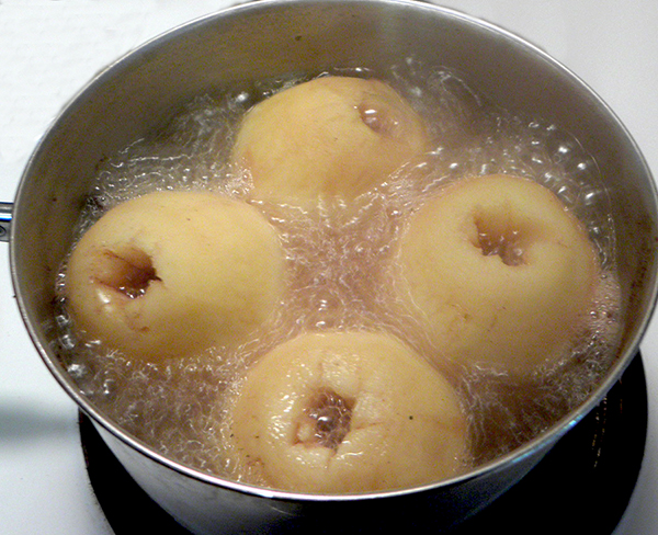 Four Apples Simmering in Spiced Juice