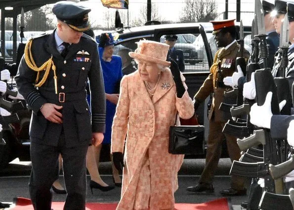 As Honorary Air Commodore, Queen Elizabeth. She wearing a peaches and cream outfit with matching hat by Angela Kelly. diamond bow brooch