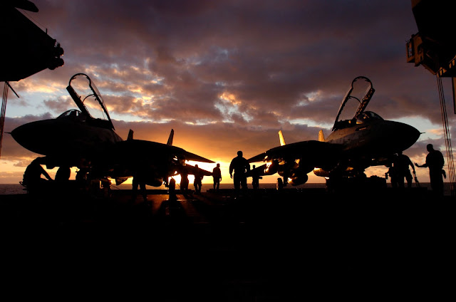 The sun sets behind a pair of F-14D Tomcats assigned to the "Tomcatters" of Fighter Squadron Three One (VF-31)
