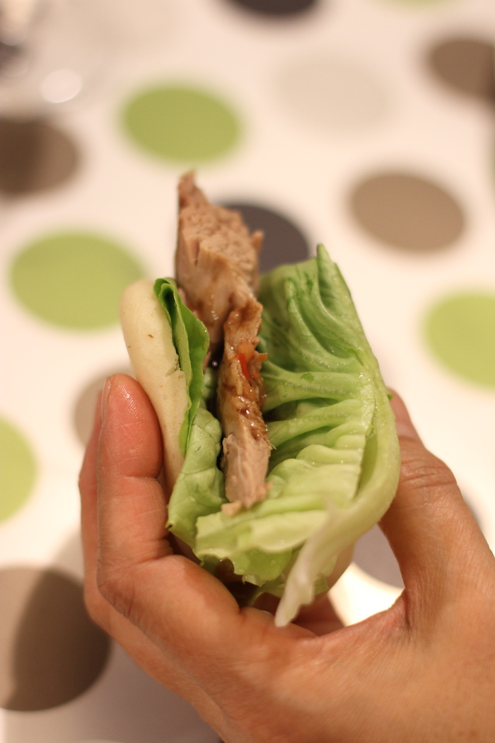 Steamed buns with roast duck and lettuce.