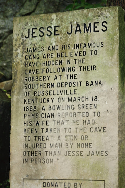 photo of historic marker about the outlaw Jesse James gang hiding out at the Lost River Cave to escape the law after robbing the Russellville, Kentucky bank in 1868 and a physician being taken to the cave to treat a sick or injured man by Jesse James. 