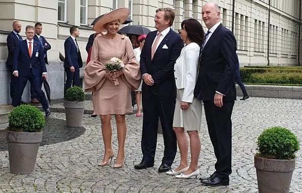 Brandenburg's Prime Minister Dietmar Woidke and his wife Susanne Woidke. Queen mMaxima wore Natan dress