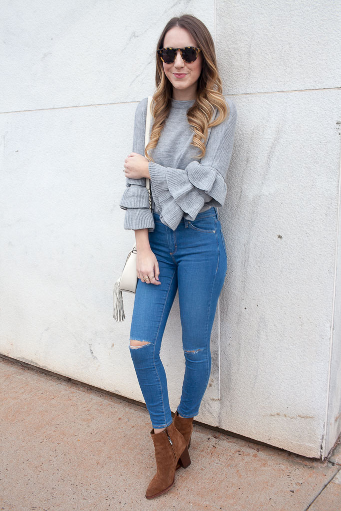 A ruffle sleeve sweater paired with distressed denim. 