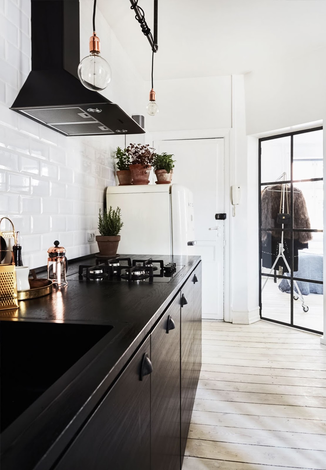 small scandinavian apartment with black kitchen and rustic wood 