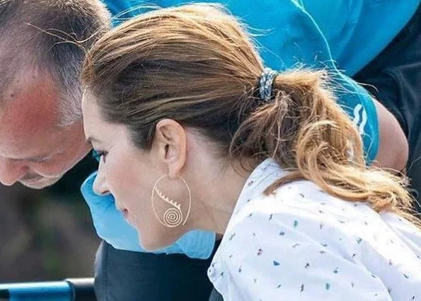 Crown Princess Mary wore a white printed shirt and black skirt. The thornback ray (Raja clavata) were released into Danish waters