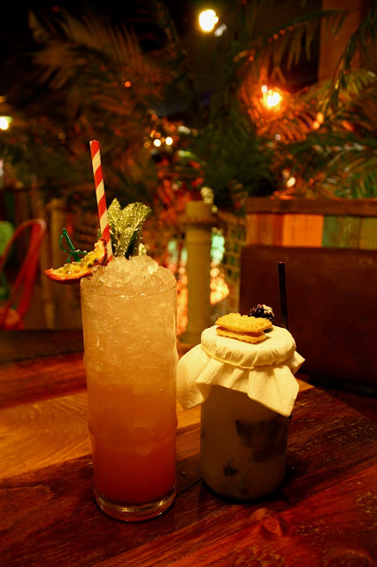 Bamboo cooler and tropical smash cocktails sitting on a table in the Treetop Adventure Golf market