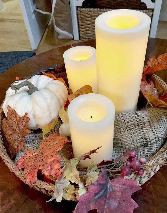 Faux candles and foliage create a one of a kind lasting centerpiece for a round table. www.homeroad.net