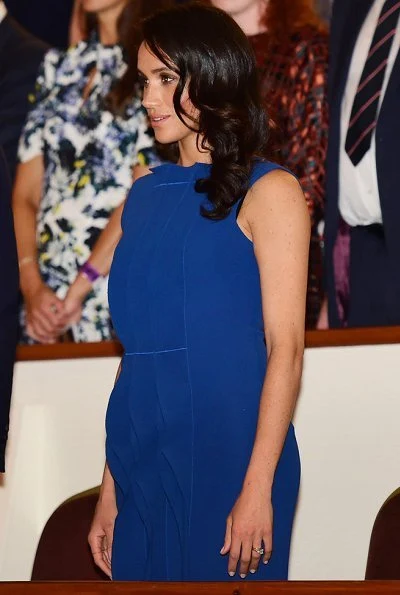 Meghan Markle wore a royal blue midi dress by Jason Wu, Aquazzura Portrait Lady pumps, she carries DIOR Navy Satin Clutch Bag
