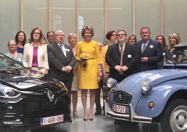 Queen Mathilde visited the Wit-Gele Kruis (White-Yellow Cross) in Gent. Queen wore Natan Dress and Delphine Nardin Gold Earrings