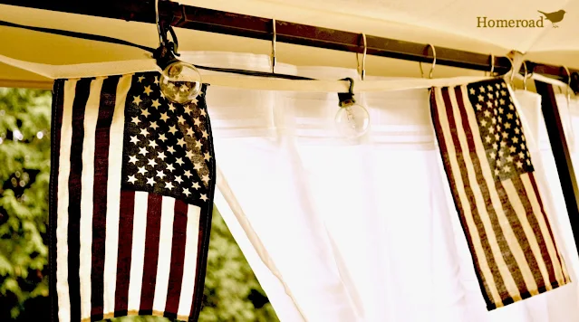 American flags hanging with lights in an outdoor gazebo
