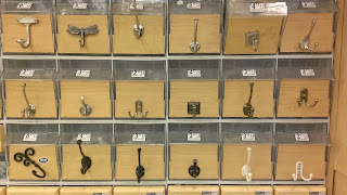 wall of hooks with prices at a store