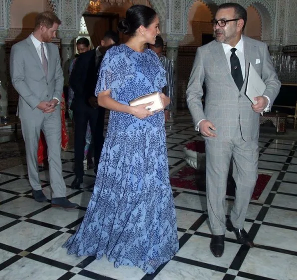 Meghan Markle wore Carolina Herrera floral printed silk chiffon short sleeve gown, and she carries Dior Bee embellished clutch