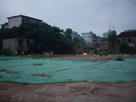 vacant lot where buildings had been demolished being used for religious offerings