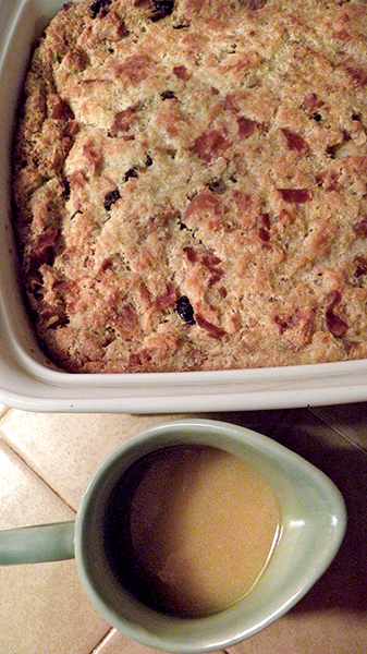 Pan of Bread Pudding with Pitcher of Bourbon Sauce
