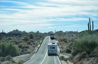 RV's driving south through cactus country.