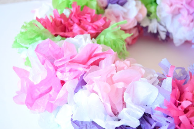Tissue Paper Flower Wreath.  Beautiful decoration for spring or summer.  Kids can help make flowers and then attach them to the wreath with this easy and beautiful craft.