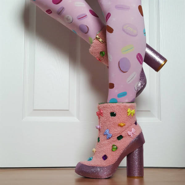 legs wearing macaron printed tights with pink shearling ankle boots