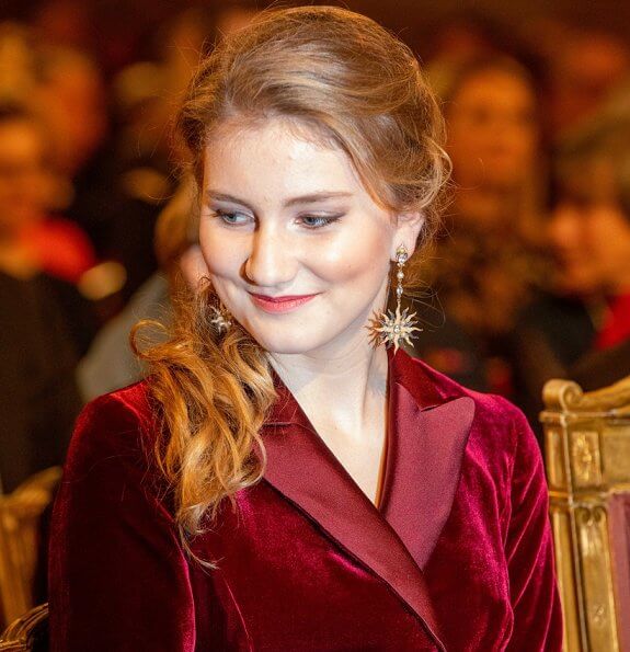 Queen Mathilde wore a floral print gown by Dries Van Noten. Crown Princess Elisabeth wore a velvet-satin jumpsuit by DVF